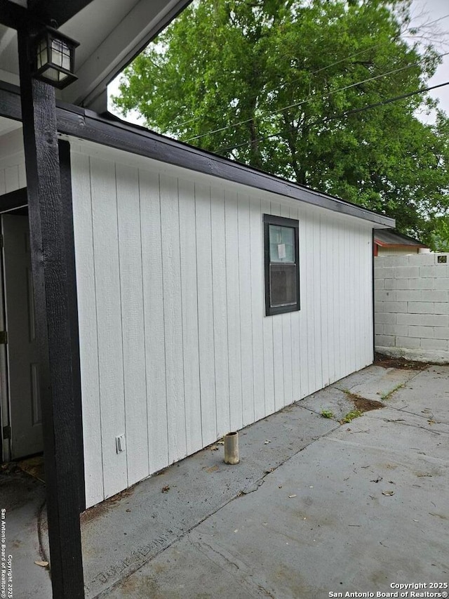 view of side of property with a patio and fence