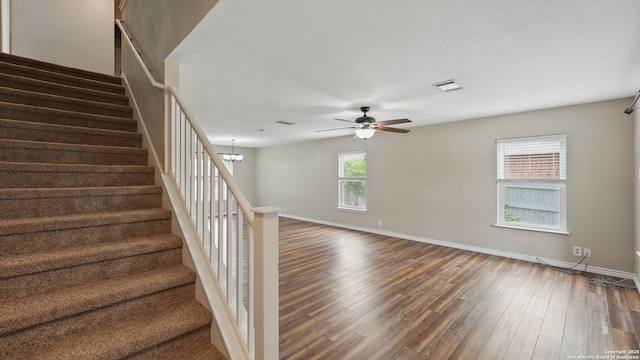744 Pinehurst, New Braunfels, TX 78130 - staircase with wood finished floors, a ceiling fan, baseboards, and a chandelier