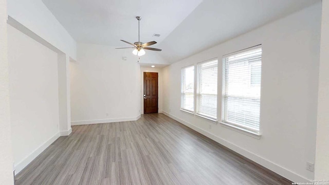 1818 Nettletree, New Braunfels, TX 78132 - unfurnished living room with vaulted ceiling, a ceiling fan, wood finished floors, and baseboards