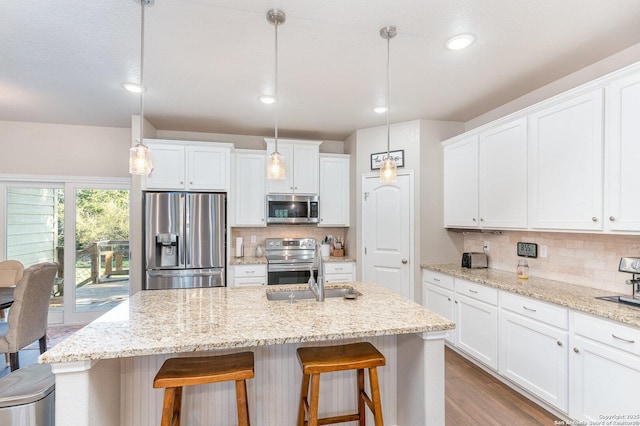 1345 Birch Ln, Fischer, TX 78623 - kitchen featuring appliances with stainless steel finishes, a sink, tasteful backsplash, white cabinets, and recessed lighting