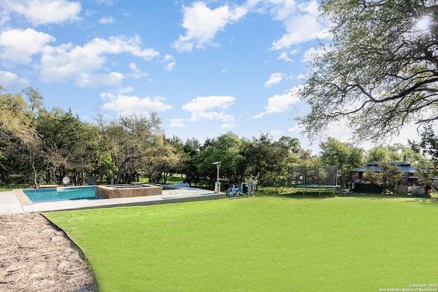 1345 Birch Ln, Fischer, TX 78623 - view of community with a trampoline, a hot tub, a yard, a swimming pool, and view of wooded area