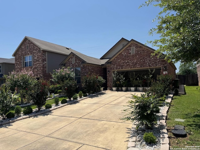 view of front of property featuring brick siding, an attached garage, and concrete driveway