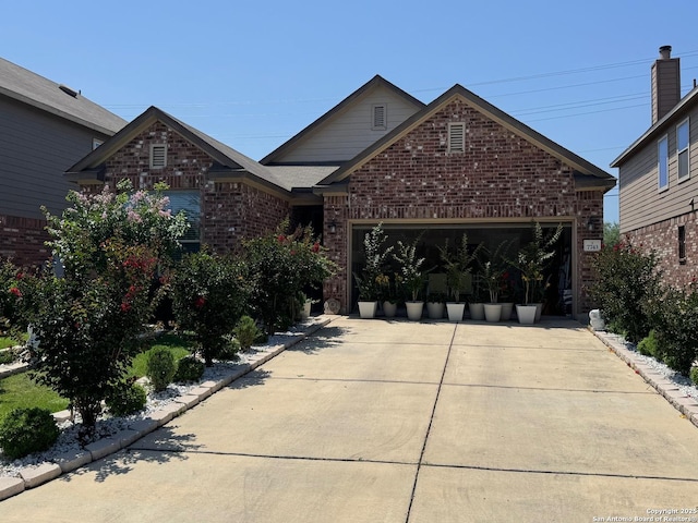 view of front of property with brick siding, concrete driveway, and a garage