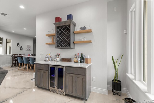 397 County Road 367, Hondo, TX 78861 - indoor dry bar featuring beverage cooler, recessed lighting, baseboards, and light marble finish floors