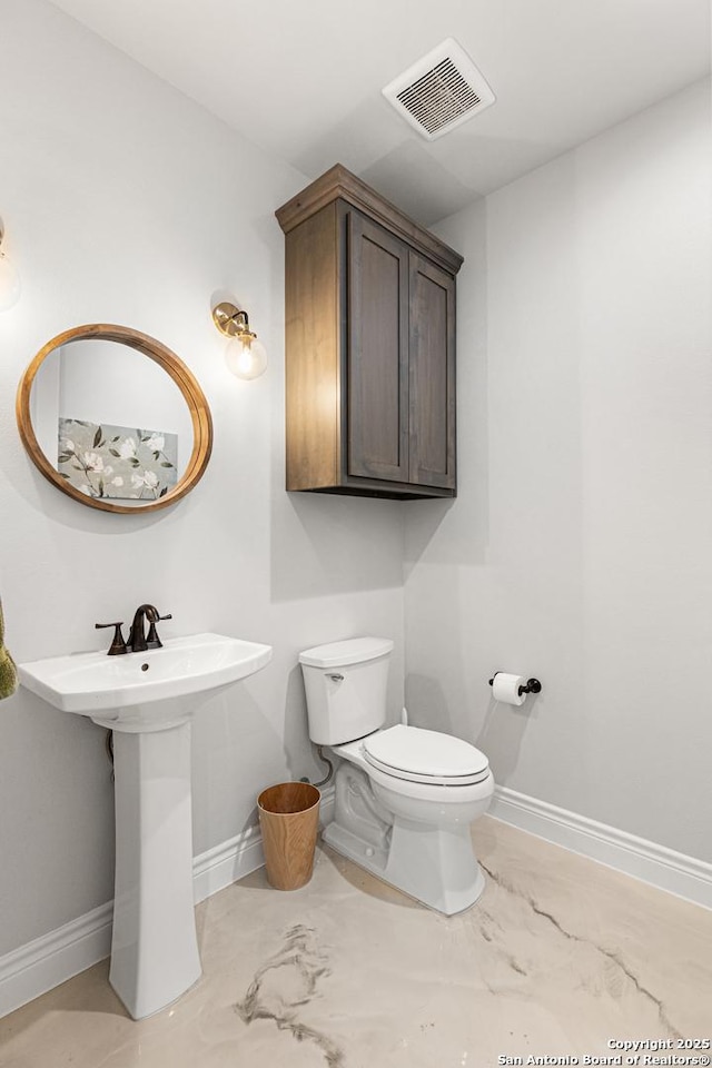 397 County Road 367, Hondo, TX 78861 - bathroom featuring toilet, baseboards, and marble finish flooring
