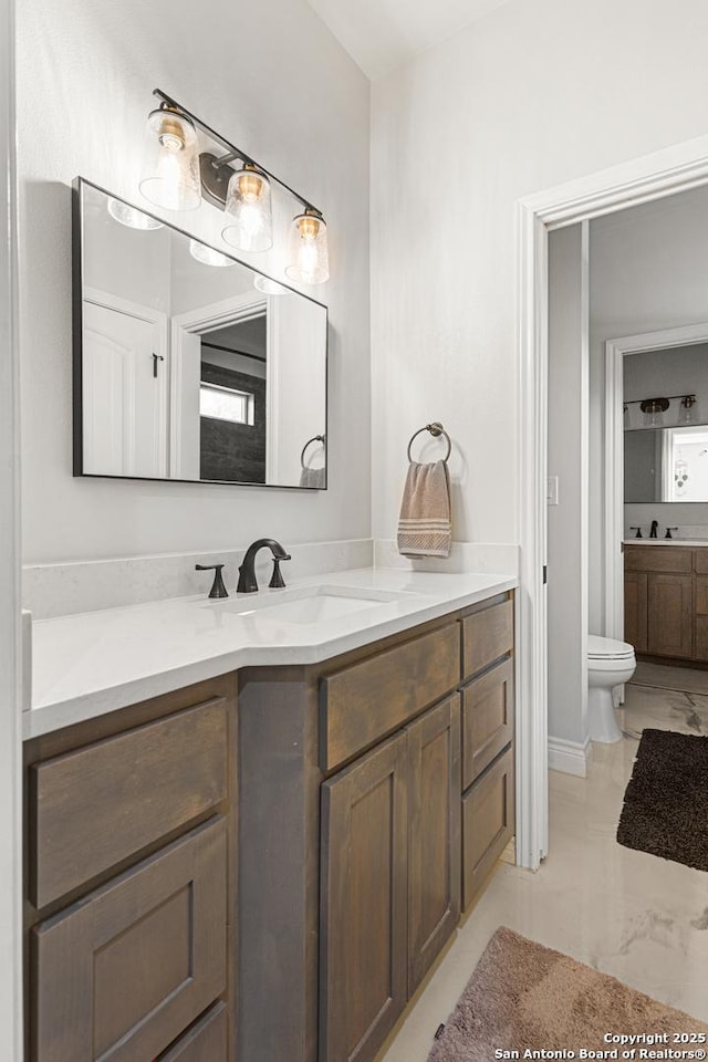 397 County Road 367, Hondo, TX 78861 - bathroom with marble finish flooring, toilet, and vanity