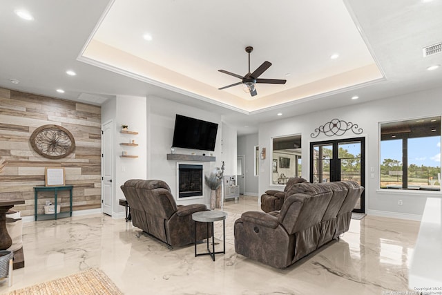 397 County Road 367, Hondo, TX 78861 - living area with a fireplace, wood walls, marble tiled floors, a raised ceiling, and recessed lighting