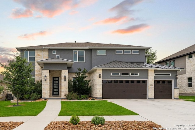 150 Cool Rock, Boerne, TX 78006 - prairie-style house with a standing seam roof, stone siding, concrete driveway, and a front lawn