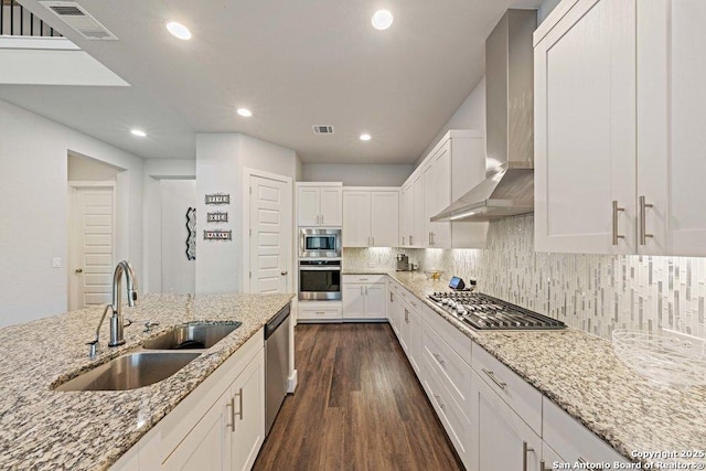 150 Cool Rock, Boerne, TX 78006 - kitchen with stainless steel appliances, a sink, wall chimney range hood, dark wood-style floors, and white cabinetry