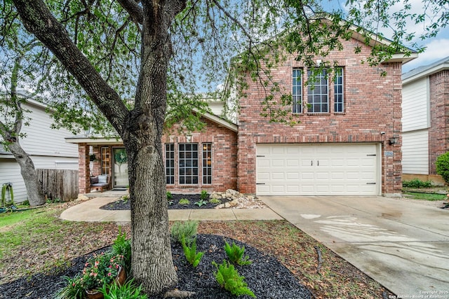 traditional home featuring brick siding, a garage, concrete driveway, and fence