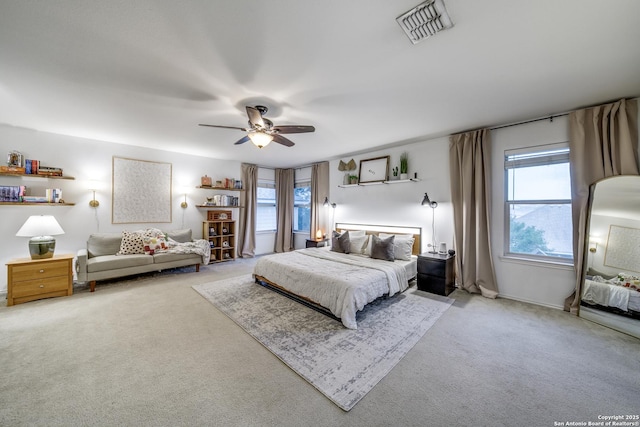 bedroom featuring light carpet, multiple windows, and ceiling fan