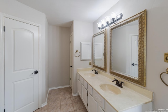 bathroom featuring baseboards, double vanity, and tile patterned flooring