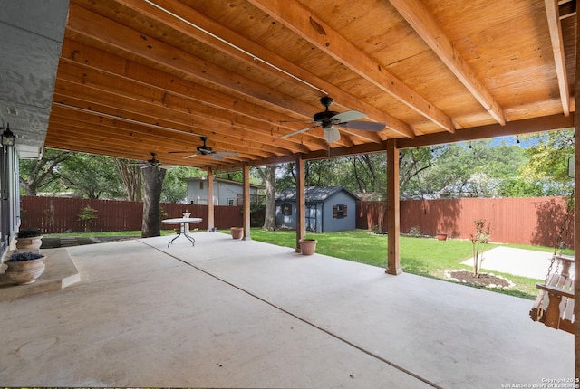 view of patio / terrace with ceiling fan and an outbuilding