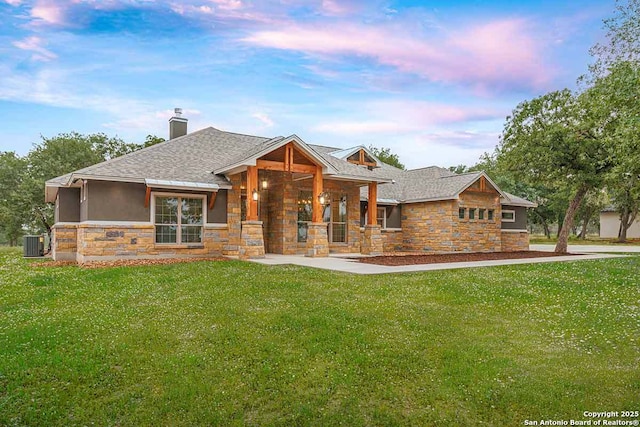 LOT52 Hondo Vis, La Vernia, TX 78121 - view of front of house with stone siding, a porch, a yard, and a shingled roof