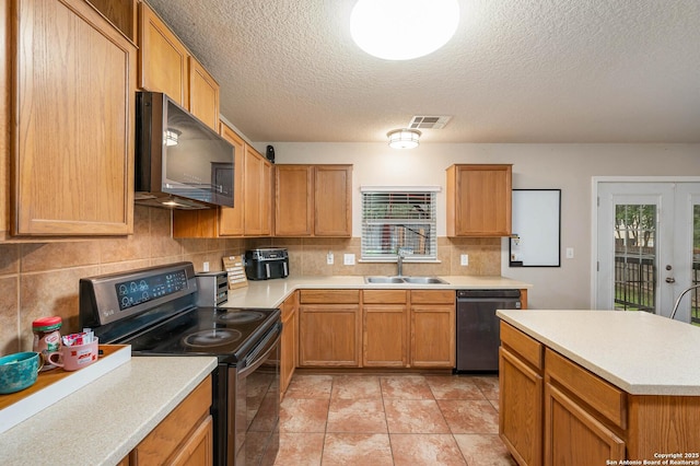 3911 Valencia Peak, San Antonio, TX 78261 - kitchen featuring appliances with stainless steel finishes, a sink, backsplash, light countertops, and a textured ceiling
