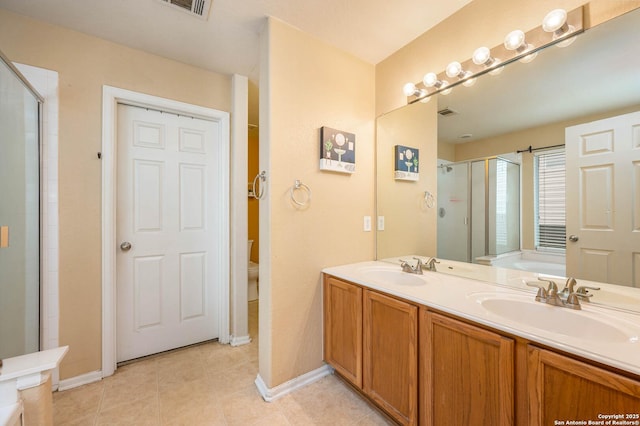 3911 Valencia Peak, San Antonio, TX 78261 - full bathroom featuring baseboards, a shower stall, tile patterned flooring, and double vanity