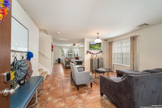 3911 Valencia Peak, San Antonio, TX 78261 - living room with stairs, a textured ceiling, and ceiling fan