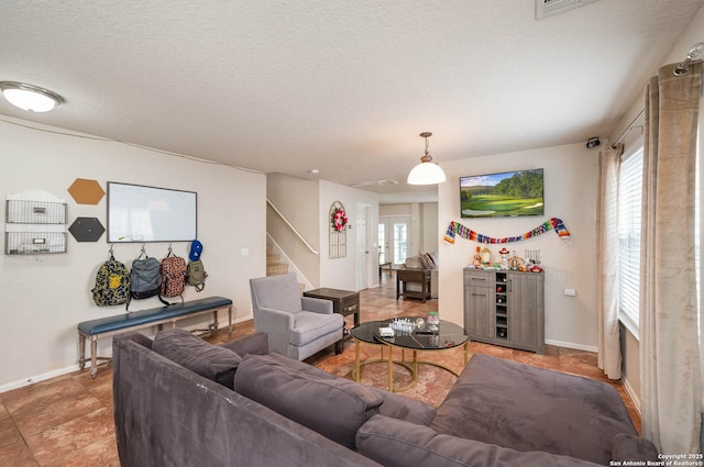 3911 Valencia Peak, San Antonio, TX 78261 - living area featuring baseboards, stairway, and a textured ceiling