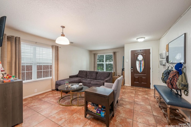 3911 Valencia Peak, San Antonio, TX 78261 - living area featuring a textured ceiling, light tile patterned floors, and baseboards