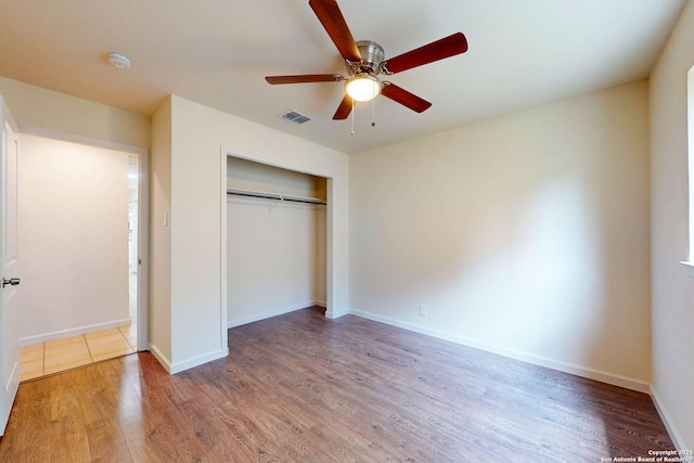 5423 Princess Diane, San Antonio, TX 78229 - unfurnished bedroom with wood finished floors, a closet, baseboards, and ceiling fan