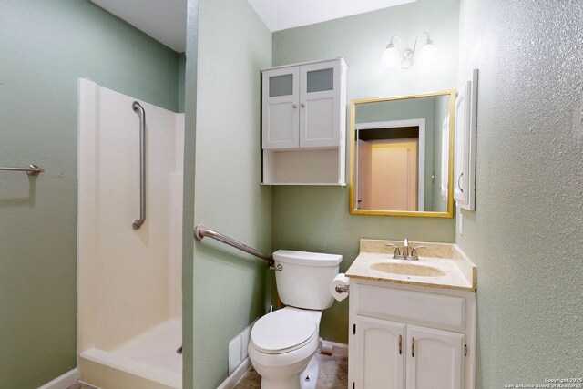 5423 Princess Diane, San Antonio, TX 78229 - full bath with a stall shower, toilet, vanity, and baseboards