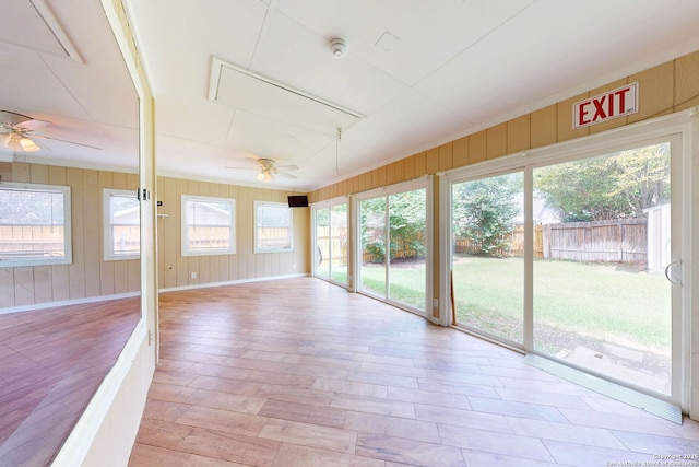 5423 Princess Diane, San Antonio, TX 78229 - unfurnished sunroom featuring a ceiling fan, wood finished floors, baseboards, and wooden walls