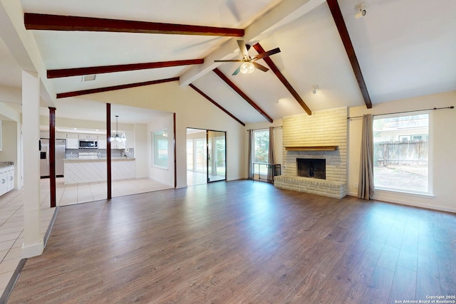 5423 Princess Diane, San Antonio, TX 78229 - unfurnished living room featuring ceiling fan, a fireplace, light wood-type flooring, beamed ceiling, and high vaulted ceiling