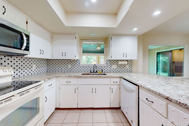 5423 Princess Diane, San Antonio, TX 78229 - kitchen featuring white appliances, a sink, tasteful backsplash, white cabinetry, and light tile patterned floors