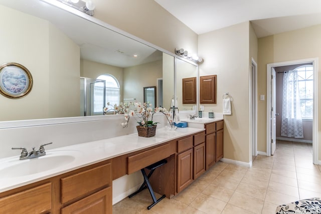 22319 Chimayo, San Antonio, TX 78258 - full bath featuring tile patterned floors, double vanity, baseboards, and a shower with shower door