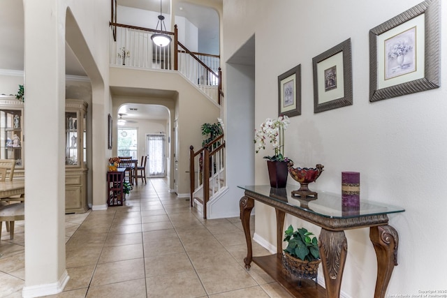 22319 Chimayo, San Antonio, TX 78258 - entryway featuring stairs, arched walkways, light tile patterned floors, baseboards, and a towering ceiling