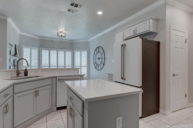 27 Sherborne Wood, San Antonio, TX 78218 - kitchen featuring a sink, dishwasher, freestanding refrigerator, a center island, and light tile patterned floors