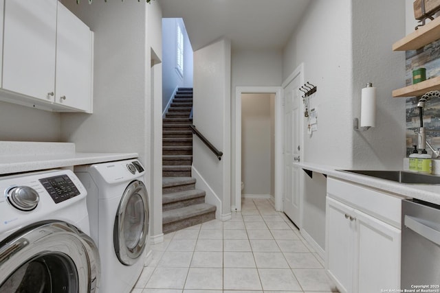 27 Sherborne Wood, San Antonio, TX 78218 - laundry area featuring washing machine and dryer, light tile patterned flooring, and cabinet space