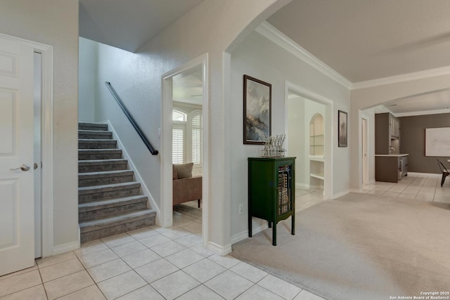 27 Sherborne Wood, San Antonio, TX 78218 - stairs featuring crown molding, tile patterned floors, baseboards, carpet flooring, and arched walkways