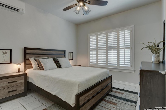 27 Sherborne Wood, San Antonio, TX 78218 - bedroom with a wall mounted air conditioner, light tile patterned floors, baseboards, and a ceiling fan