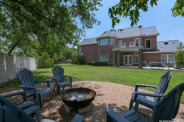 27 Sherborne Wood, San Antonio, TX 78218 - back of property with an outdoor fire pit, brick siding, french doors, a patio, and a standing seam roof