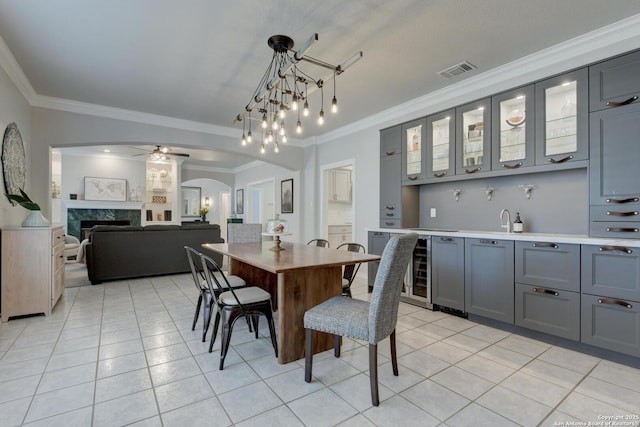 27 Sherborne Wood, San Antonio, TX 78218 - dining space with arched walkways, ornamental molding, light tile patterned floors, a ceiling fan, and bar with sink