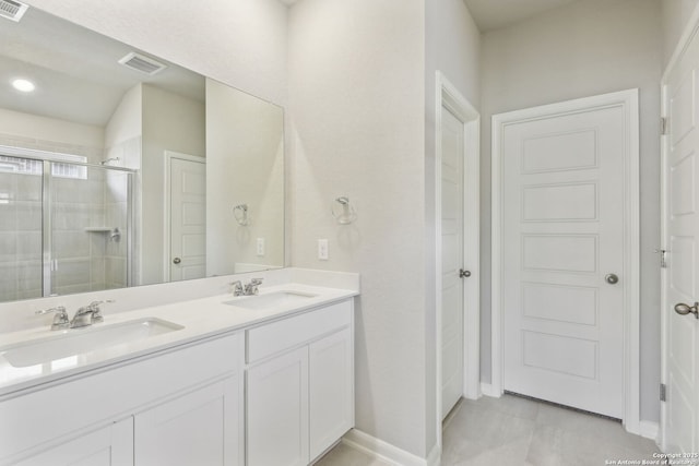 11515 Cottage Pt, San Antonio, TX 78254 - full bathroom with a stall shower, double vanity, and baseboards