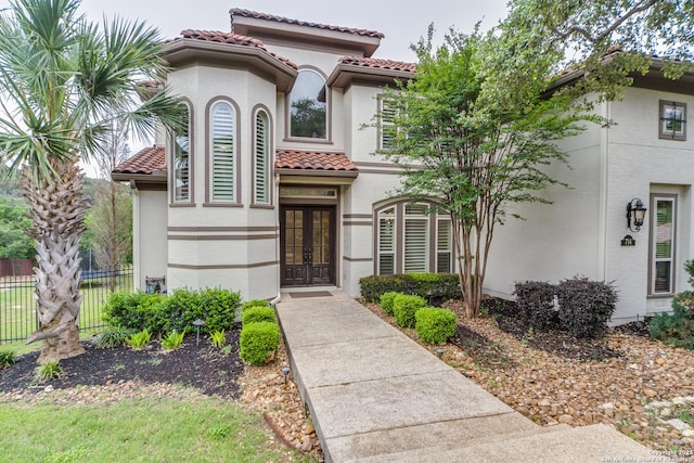 714 Ruidosa Downs, Helotes, TX 78023 - mediterranean / spanish house with french doors, fence, a tile roof, and stucco siding