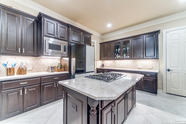 714 Ruidosa Downs, Helotes, TX 78023 - kitchen with appliances with stainless steel finishes, crown molding, decorative backsplash, glass insert cabinets, and a kitchen island