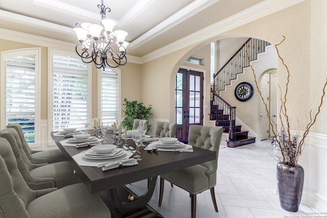 714 Ruidosa Downs, Helotes, TX 78023 - dining room with french doors, arched walkways, ornamental molding, a chandelier, and a wainscoted wall