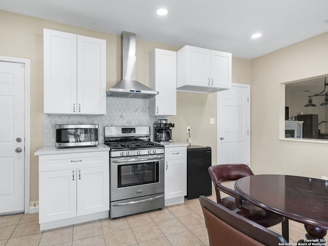 928 W Huisache, San Antonio, TX 78201 - kitchen with stainless steel appliances, wall chimney range hood, decorative backsplash, white cabinetry, and recessed lighting
