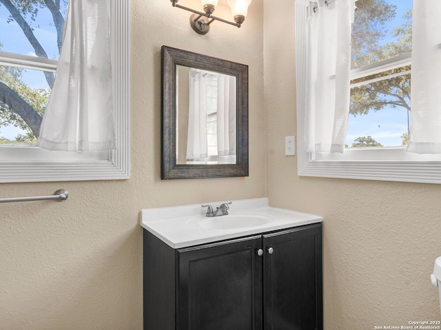 928 W Huisache, San Antonio, TX 78201 - bathroom featuring a textured wall and vanity