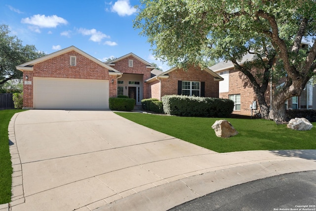traditional-style house with an attached garage, driveway, brick siding, and a front lawn