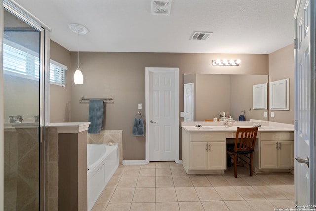 full bath featuring tile patterned flooring, a bath, a shower stall, double vanity, and baseboards