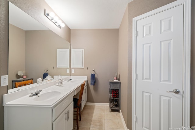 full bath with tile patterned flooring, double vanity, and baseboards
