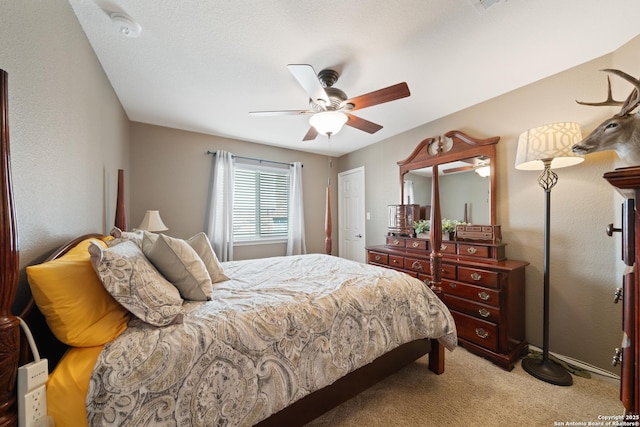 bedroom featuring light colored carpet and ceiling fan