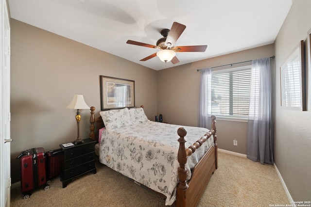 bedroom featuring light colored carpet, baseboards, and ceiling fan
