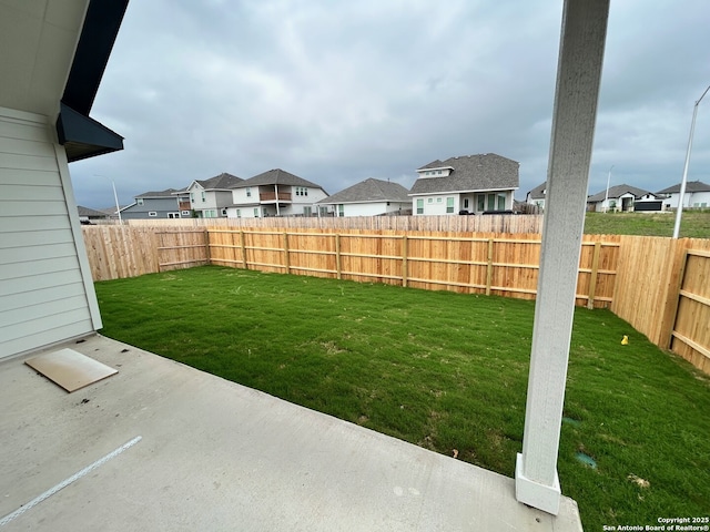 view of yard featuring a residential view and a patio