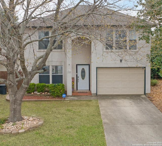 view of front of property featuring stucco siding, an attached garage, driveway, and a front yard