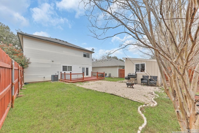 back of house with a wooden deck, an outdoor fire pit, and cooling unit